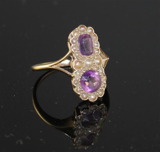 An early to mid 20th century 9ct, amethyst and seed pearl set double cluster dress ring,